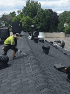 A man servicing a shingle roof in Toronto