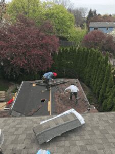 Two men repairing a roof